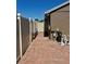 The side yard features a brick-paved walkway leading to a gated area with the property's utility equipment at 2015 Golf Manor Blvd, Valrico, FL 33596