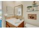 Bright bathroom with a decorative mirror, tiled backsplash, and modern fixtures at 210 Fernwood Cir # 210, Seminole, FL 33777