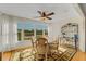 Cozy dining room featuring a ceiling fan, natural light, and a charming display case at 210 Fernwood Cir # 210, Seminole, FL 33777