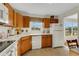 Classic kitchen featuring oak cabinets and a large window offering abundant natural light at 210 Fernwood Cir # 210, Seminole, FL 33777