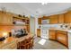 Bright eat-in kitchen features a built-in desk and oak cabinets at 210 Fernwood Cir # 210, Seminole, FL 33777
