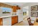 Traditional kitchen with a view of a sunny Florida neighborhood at 210 Fernwood Cir # 210, Seminole, FL 33777