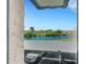 Scenic water view showcasing lush greenery and a glimpse of the parking area from a window at 210 Fernwood Cir # 210, Seminole, FL 33777