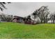 Spacious backyard featuring a lawn and trees surrounding the property at 22819 Southshore Dr, Land O Lakes, FL 34639