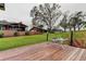 Expansive backyard with outdoor patio, lush green lawn, mature trees, and waterfront access at 22819 Southshore Dr, Land O Lakes, FL 34639