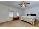 A cozy bedroom with a ceiling fan and windows letting in natural light at 22819 Southshore Dr, Land O Lakes, FL 34639