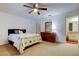 Bedroom featuring hardwood floors, a ceiling fan, a dresser and access to an ensuite bathroom at 22819 Southshore Dr, Land O Lakes, FL 34639