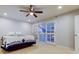 Bedroom featuring hardwood floors, a ceiling fan, and french doors leading to an outdoor balcony at 22819 Southshore Dr, Land O Lakes, FL 34639