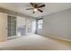 Bright bedroom featuring carpeted floors, a ceiling fan, and sliding glass doors at 22819 Southshore Dr, Land O Lakes, FL 34639