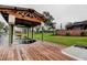 View of the boat dock structure with waterfront backyard and home in the background at 22819 Southshore Dr, Land O Lakes, FL 34639