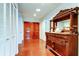 Entryway features double doors, antique buffet, and a closet for storage with red brick flooring throughout at 22819 Southshore Dr, Land O Lakes, FL 34639