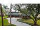 Exterior shot of a home with a lush front yard and a long, curving driveway at 22819 Southshore Dr, Land O Lakes, FL 34639