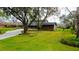 Charming home with mature trees and a well-manicured front lawn at 22819 Southshore Dr, Land O Lakes, FL 34639