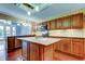 Kitchen featuring wood cabinets, island, and stainless steel appliances at 22819 Southshore Dr, Land O Lakes, FL 34639