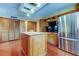 Kitchen featuring wood cabinets, island, and stainless steel appliances at 22819 Southshore Dr, Land O Lakes, FL 34639