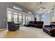 An open living room with a ceiling fan, large windows, and comfortable seating at 22819 Southshore Dr, Land O Lakes, FL 34639