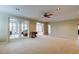 Open living room with neutral carpet and access to outdoor living spaces from multiple sets of french doors at 22819 Southshore Dr, Land O Lakes, FL 34639