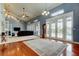 Spacious living room featuring wood floors, large windows, and neutral carpet at 22819 Southshore Dr, Land O Lakes, FL 34639