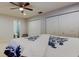 This bedroom offers a ceiling fan, a bathroom, and a large closet with mirrored doors for storage solutions at 22819 Southshore Dr, Land O Lakes, FL 34639
