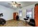 Bright office with wood laminate flooring, windows with blinds, and a ceiling fan at 22819 Southshore Dr, Land O Lakes, FL 34639