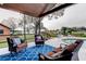 Relaxing screened patio with comfortable seating overlooking the sparkling pool and waterfront views at 22819 Southshore Dr, Land O Lakes, FL 34639