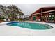 Inviting pool area with spacious patio, lush landscaping and an outdoor dining space at 22819 Southshore Dr, Land O Lakes, FL 34639