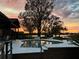 Outdoor pool with a view of the sunset and lake makes for a picturesque and relaxing backyard scene at 22819 Southshore Dr, Land O Lakes, FL 34639