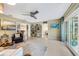 Inviting living room with neutral tones, a ceiling fan, and sliding glass doors to outdoor space at 2370 Jones Dr, Dunedin, FL 34698