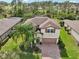 This aerial view shows the lovely landscaping and brick paved driveway of the charming two-story home at 2515 Sherman Oak Dr, North Port, FL 34289