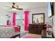 Bedroom with ceiling fan, bright pink curtains, and a comfortable bed at 2515 Sherman Oak Dr, North Port, FL 34289