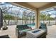 Enjoy outdoor living on the screened patio featuring comfortable seating and views of the inviting in-ground pool at 2515 Sherman Oak Dr, North Port, FL 34289