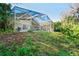 View of rear home exterior featuring an enclosed screened-in pool at 2524 Clareside Dr, Valrico, FL 33596