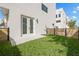 A fenced backyard with a well-maintained lawn and a white exterior of a modern home at 307 15Th N St, St Petersburg, FL 33705