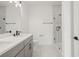 Bright bathroom featuring a double sink vanity, glass enclosed shower, and modern fixtures at 307 15Th N St, St Petersburg, FL 33705