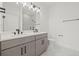 Bathroom with double sink vanity, modern lighting, and neutral color palette at 307 15Th N St, St Petersburg, FL 33705