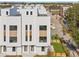 Aerial view of a modern townhouse with a white exterior, multiple windows, and a well-manicured lawn at 307 15Th N St, St Petersburg, FL 33705