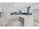 Bright kitchen features white cabinetry, a large center island, and stylish blue backsplash at 307 15Th N St, St Petersburg, FL 33705