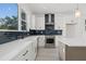 Bright kitchen features white cabinetry, stainless steel appliances, and stylish blue backsplash at 307 15Th N St, St Petersburg, FL 33705