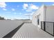 Spacious rooftop deck with gray flooring, white walls, and black railings, ideal for outdoor relaxation at 307 15Th N St, St Petersburg, FL 33705