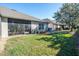 The spacious backyard features well-maintained lawn and a screened lanai for enjoying the outdoors at 31826 Larkenheath Dr, Wesley Chapel, FL 33543