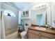 Charming bathroom features a tub with shower and ample vanity space at 31826 Larkenheath Dr, Wesley Chapel, FL 33543