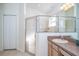 Well-lit bathroom featuring a glass-enclosed shower and vanity at 31826 Larkenheath Dr, Wesley Chapel, FL 33543