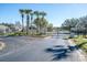 Elegant gated community entrance with lush landscaping and decorative gate at 31826 Larkenheath Dr, Wesley Chapel, FL 33543