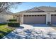 Charming home featuring a two-car garage and well-manicured landscaping at 31826 Larkenheath Dr, Wesley Chapel, FL 33543