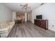 Bright, open-concept living room features modern flooring and a ceiling fan at 31826 Larkenheath Dr, Wesley Chapel, FL 33543