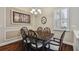 Charming dining room featuring a dark wood table set, decorative lighting, and plantation shutters at 3339 Diamond Falls Cir, Land O Lakes, FL 34638