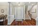 Welcoming foyer with elegant white columns, detailed trim, and rich hardwood floors leads to the staircase at 3339 Diamond Falls Cir, Land O Lakes, FL 34638