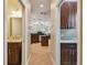 Hallway view showcasing a glimpse of the kitchen and adjacent half bathroom, creating a smooth flow at 3339 Diamond Falls Cir, Land O Lakes, FL 34638