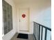 Condo front door with decorative wreath, and privacy glass block window at 3367 Crystal E Ct # F, Palm Harbor, FL 34685