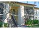 Two-story condo building with stair access to the upper units and well-maintained landscaping at 3367 Crystal E Ct # F, Palm Harbor, FL 34685